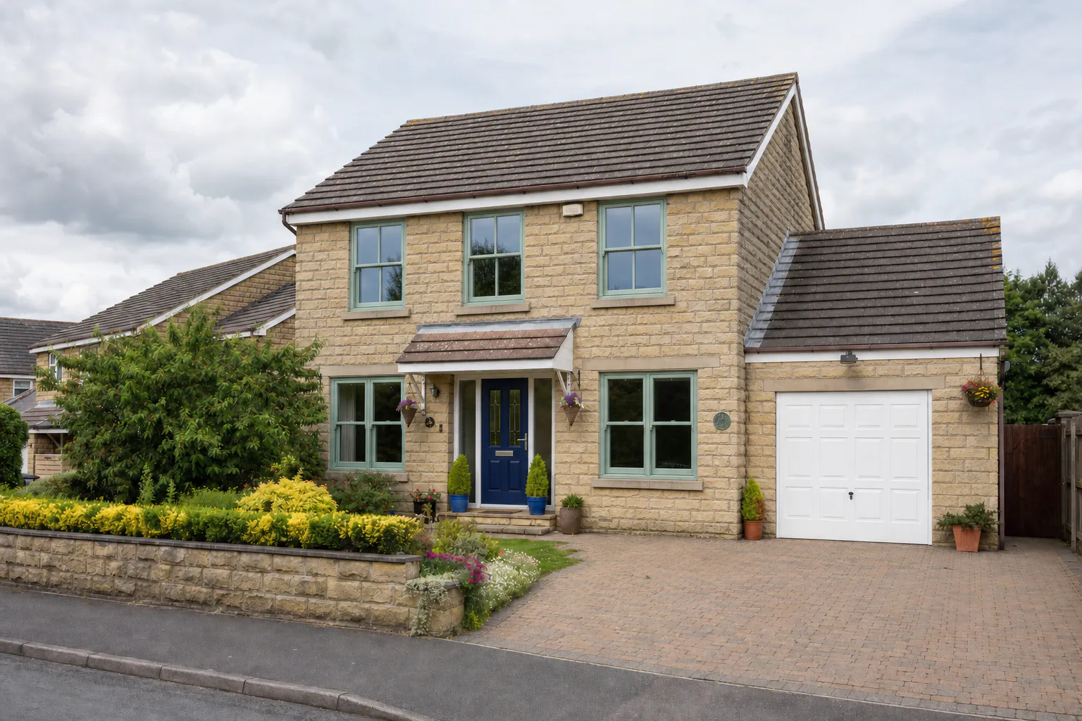 Detached Yorkshire stone house — Chartwell Green flush sash windows with navy blue front door