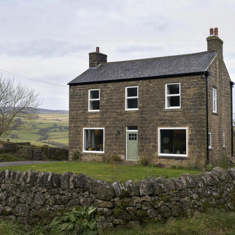 Stone farmhouse with uPVC casement windows on the edge of a Yorkshire village