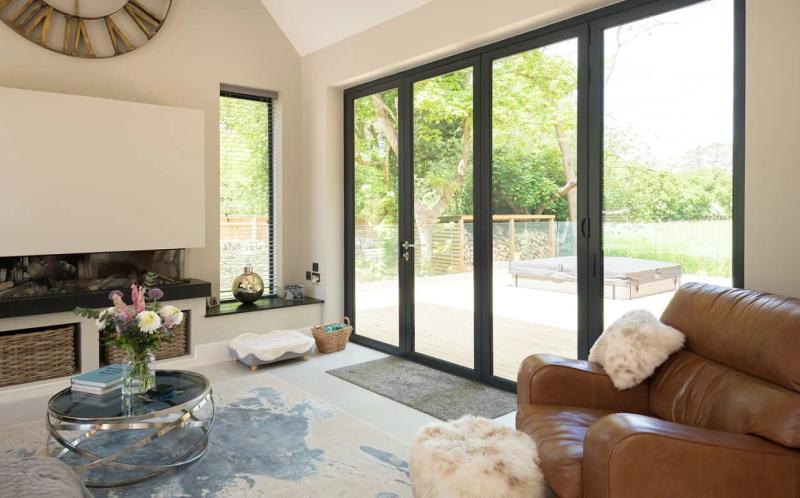 Grey aluminium bi-fold doors on a modern rear extension