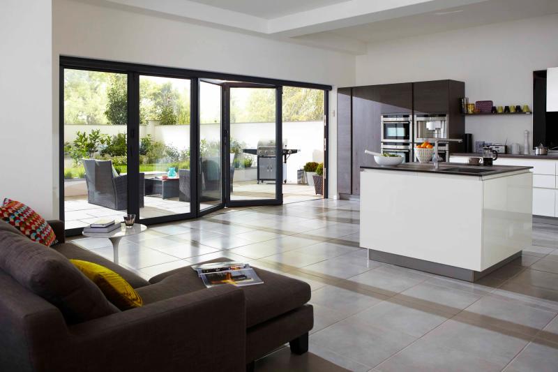 Aluminium bi-fold doors opening a kitchen onto the garden